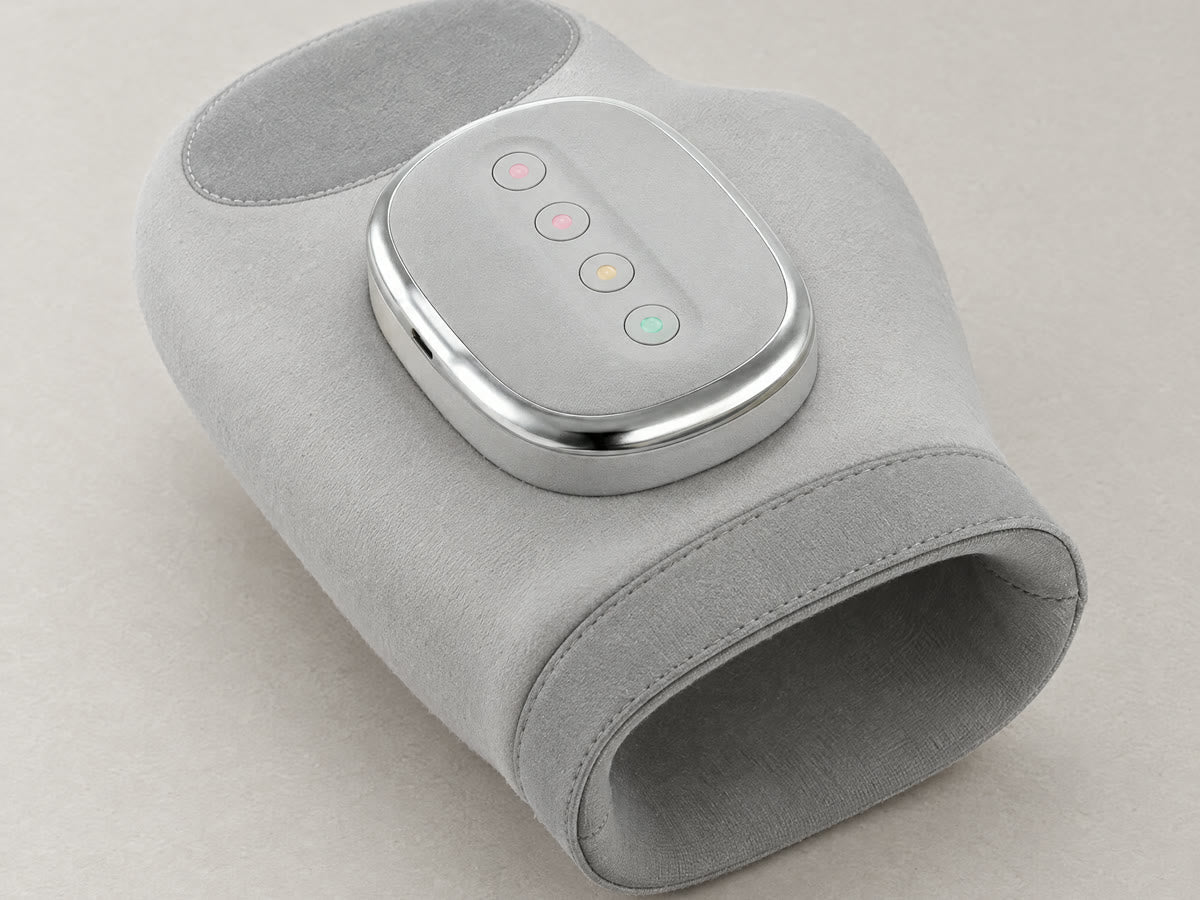 The Hand Massager, a soft grey glove-shaped device